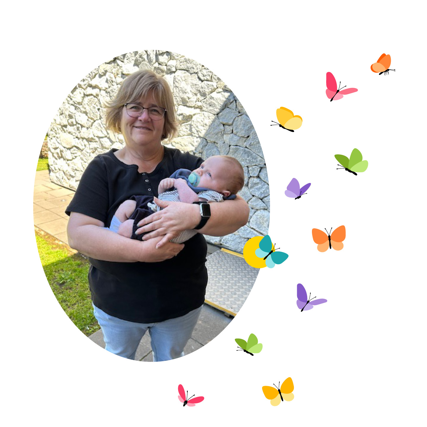 Woman standing up smiling while holding a baby