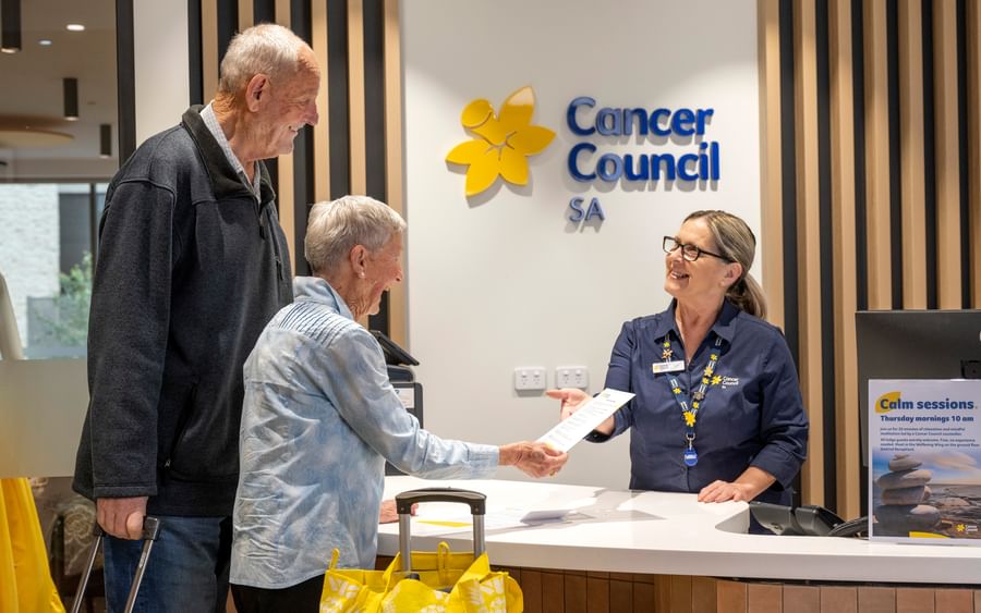 Older couple checking in at Greenhill lodge and talking to receptionist